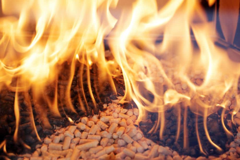Alternative Fuel: Wood Pellets Burning In A Fireplace.